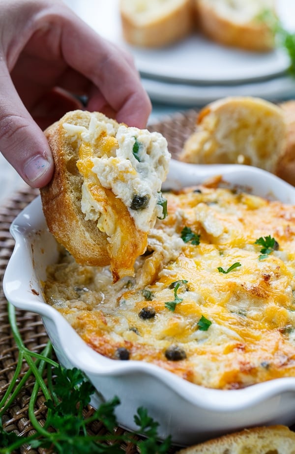 Incredible Hot Crab Dip made with crab meat, cream cheese, mayo, horseradish, capers, and cheddar cheese