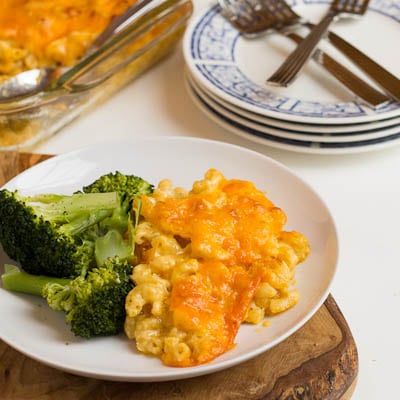 Mac and Cheese on a plate with broccoli.