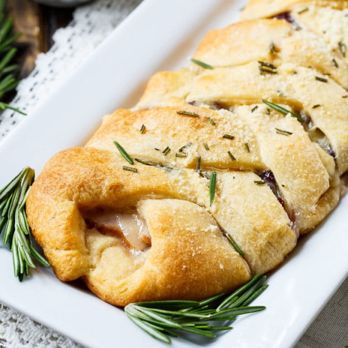 Turkey, Cranberry, and Brie Crescent Braid on a rectangular serving platter.