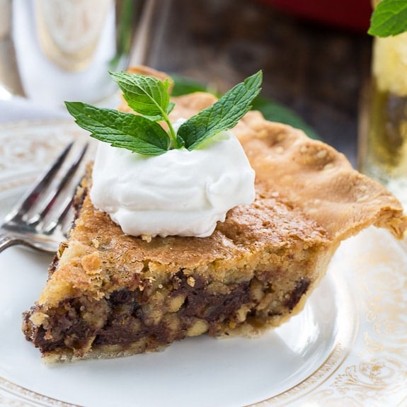 Kentucky Derby Pie has a gooey chocolate and walnut filling with a splash of bourbon. Top with bourbon whipped cream!