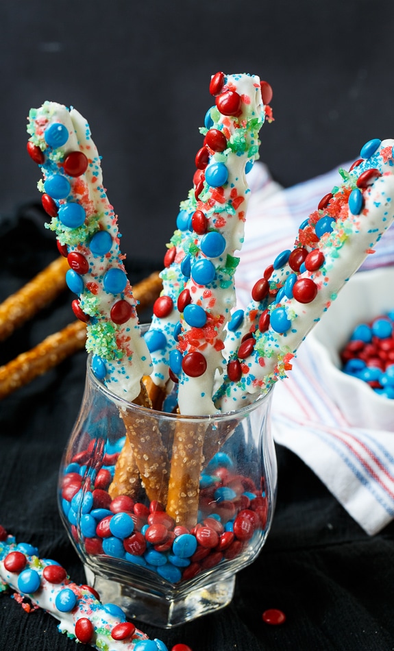 Firecracker Pretzel Rods for the 4th of July. Covered in red and blue mini M&Ms and Pop Rocks candy.