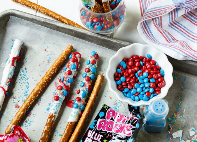 Firecracker Pretzel Rods for the 4th of July. Covered in Pop Rocks candy.