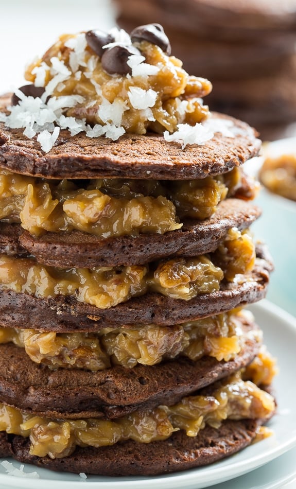 German Chocolate Pancakes - chocolate pancakes layered with a thick coconut-pecan filling. Insanely delicious recipe from Southern Living.