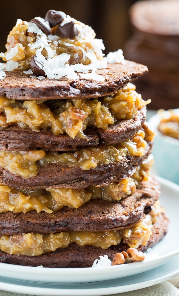 German Chocolate Pancakes - chocolate pancakes layered with a thick coconut-pecan filling. Insanely delicious recipe from Southern Living.