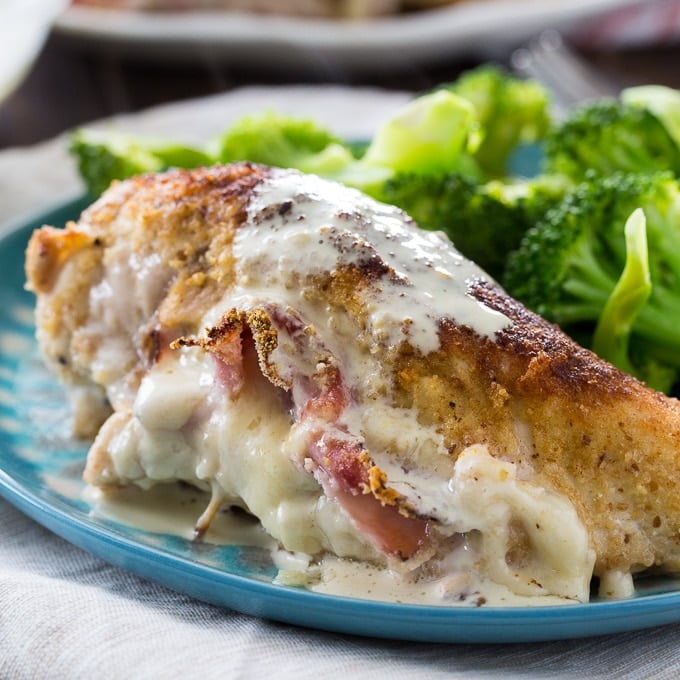 Ham and Cheese Stuffed Chicken on a plate with broccoli.
