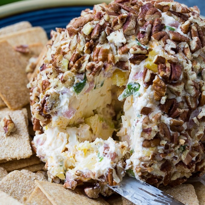 Ham and Pineapple Cheese Ball on a plate with crackers