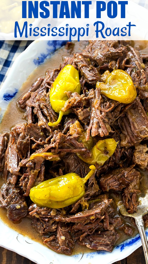 Shredded Roast on a serving platter with pepperoncini peppers.