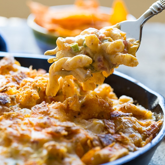 King Ranch Casserole in mac and cheese form. Spicy and creamy with diced chicken and a crushed dorito topping.