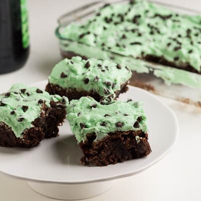 Brownies with Mint Frosting on a white plate.