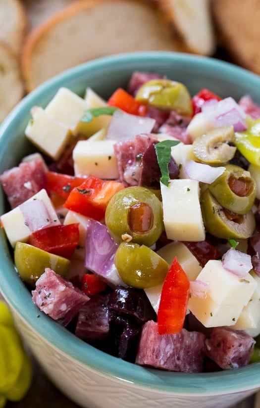 Muffaletta Dip with cheese, salami, and olives. An easy make ahead party food.