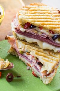 Muffaletta Panini with 3kinds of meat, provolone cheese, and olive relish.