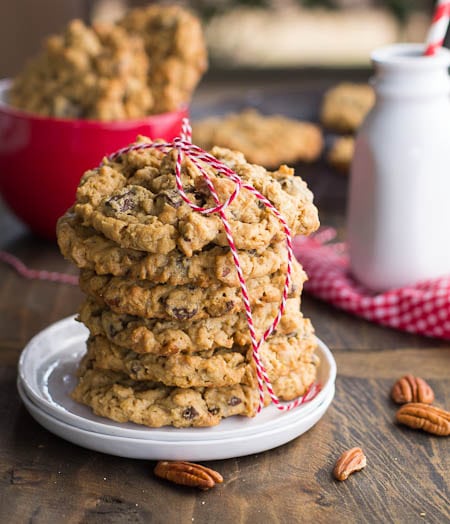 Stack of cookies on plate with red and white twine tied around them.