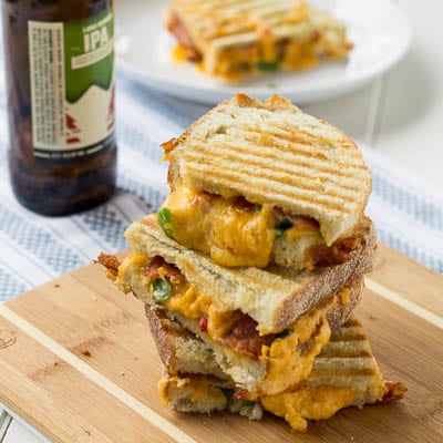 Pimiento Cheese Panini cut in half and stacked on a cutting board.