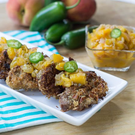 Pecan-Crusted Pork Medallions topped with peach chutney and jalapeno slices.