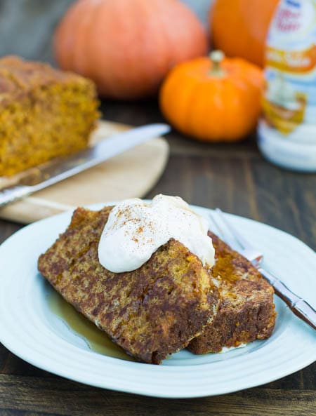 Two slices of French Toast with pumpkins in background.