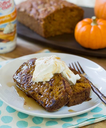 Pumpkin Spice Bread French Toast on a plate topped with whipped cream.