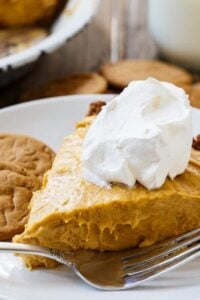 Slice of Marshmallow Pumpkin Pie topped with whipped cream.