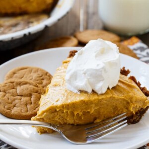 Slice of Marshmallow Pumpkin Pie topped with whipped cream.