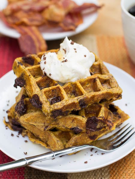 Pumpkin Chocolate Chunk Waffles topped with whipped cream.