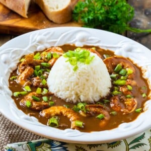 Shrimp Etouffe topped with rice in a bowl.