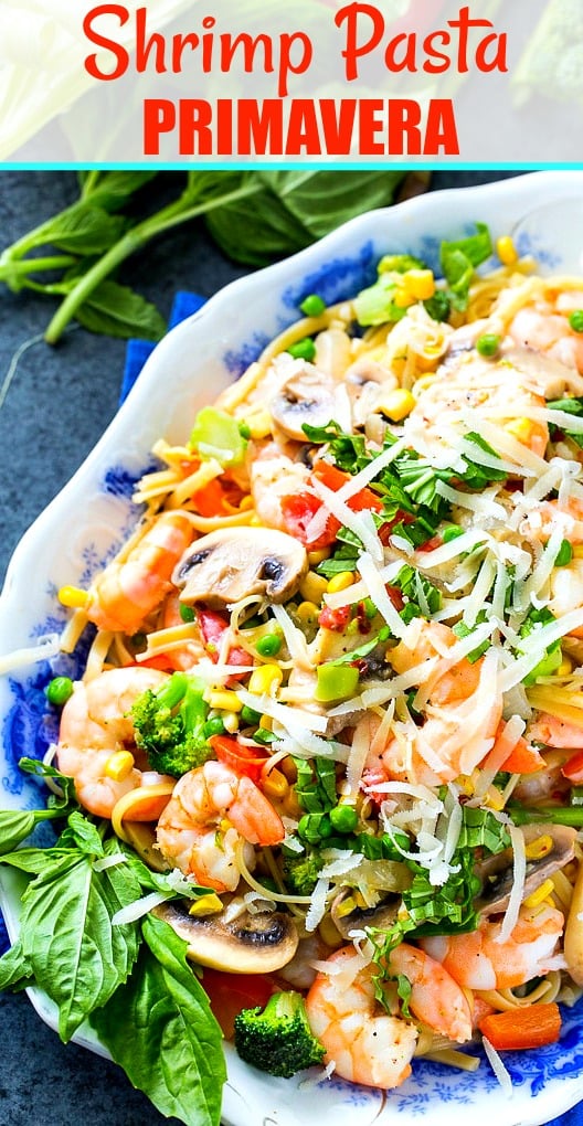 Shrimp Primavera on a serving plate with fresh basil.
