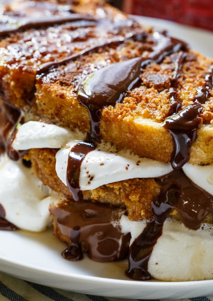 S'mores French Toast- coated in crushed graham crackers and stuffed with marshmallows and Hershey chocolate.