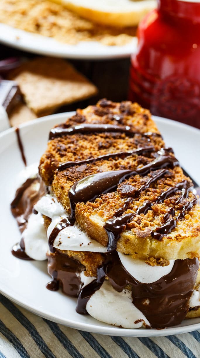 S'mores French Toast- coated in crushed graham crackers and stuffed with marshmallows and Hershey chocolate.