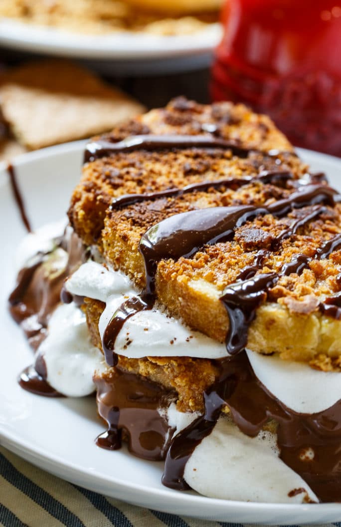 S'mores French Toast- coated in crushed graham crackers and stuffed with marshmallows and Hershey chocolate.