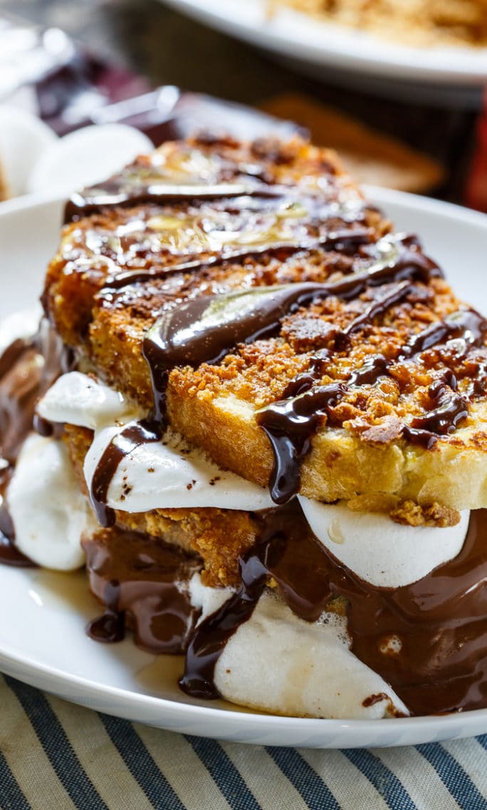 S'mores French Toast- coated in crushed graham crackers and stuffed with marshmallows and Hershey chocolate.