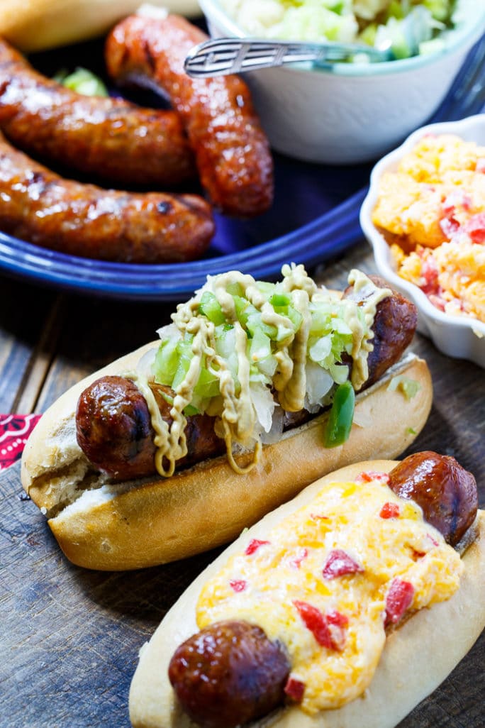 Grilled Brats topped with Pimento Cheese and Green Tomato Chow Chow