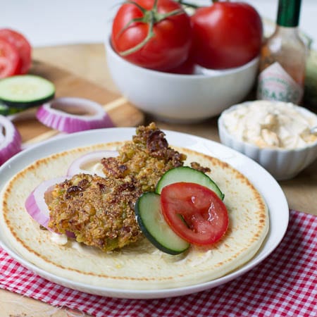 Southern Falafel on pita bread with red onion, cucumbers, and tomato.