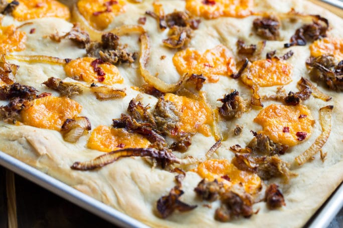 Southern-Style Focaccia with pulled pork, pimento cheese, and vidalia onions.