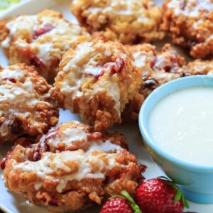 Glazed Strawberry Fritters are crisp on the outside with chunks of fresh strawberry on the inside.