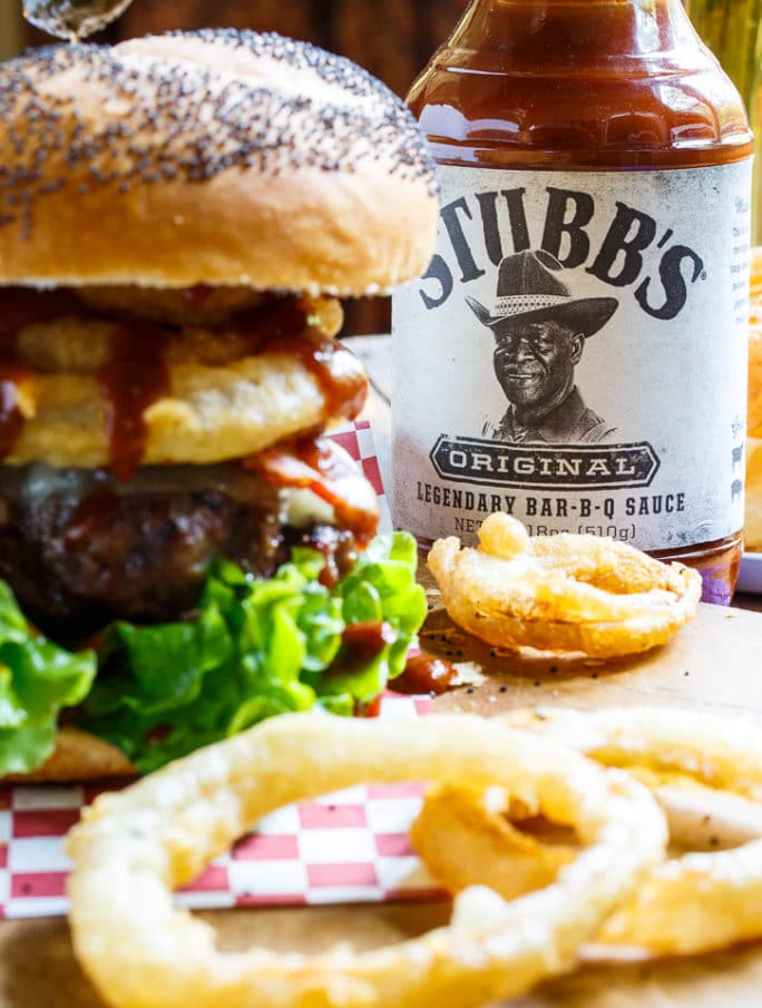 Cowboy Burger topped with bacon, onion rings, and bbq sauce.