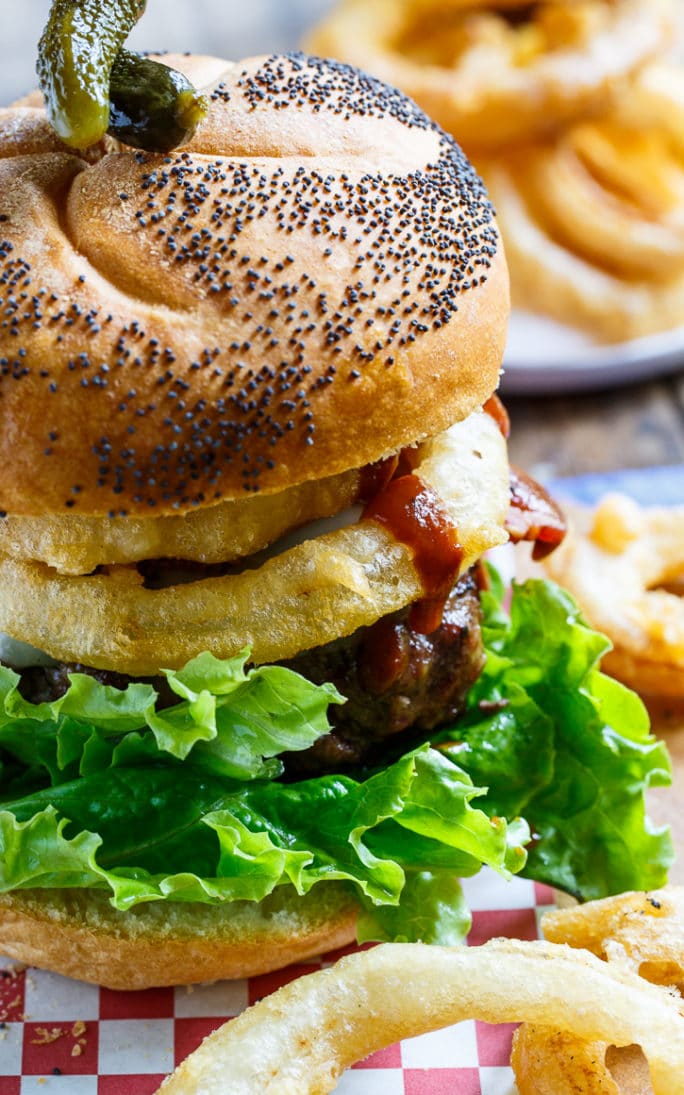 Cowboy BUrgers topped with bacon, onion rings, and bbq sauce.