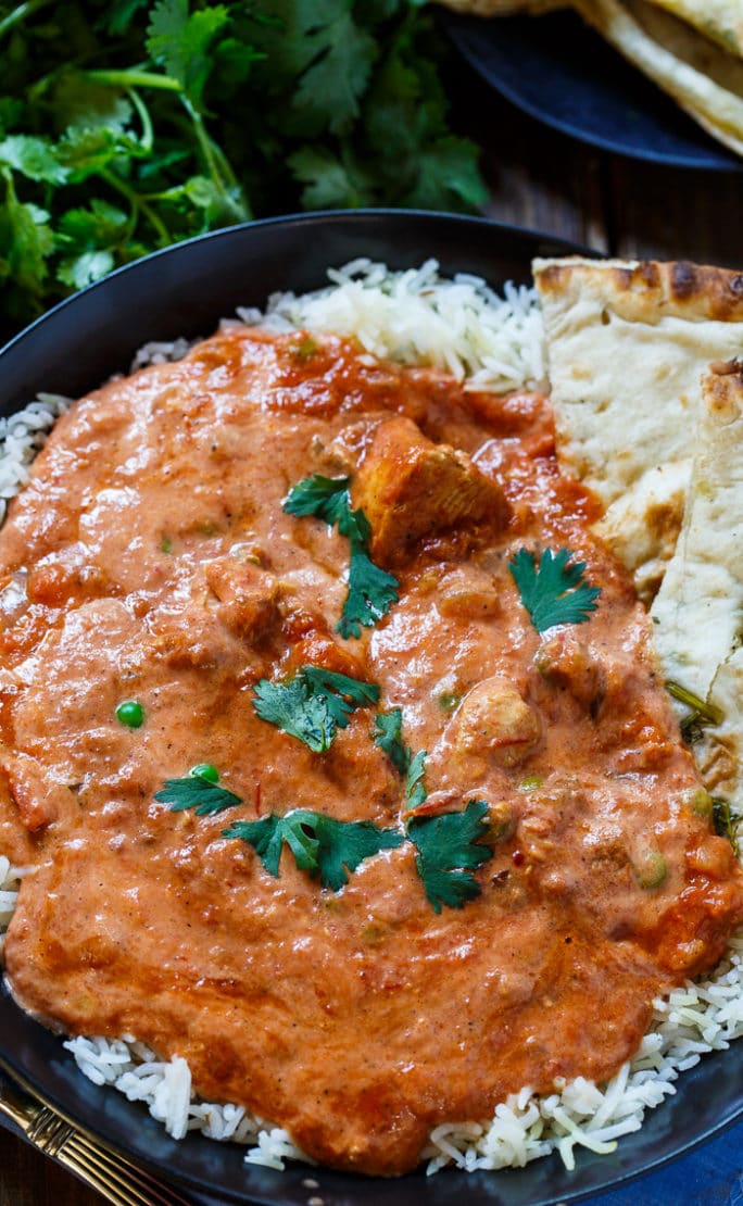 Chicken Tikka Masala over rice with fresh cilantro.