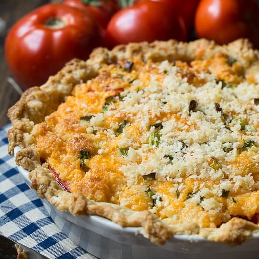 Savory Tomato Pie Recipe- a southern favorite. Juicy summer tomatoes mixed with mayonnaise and cheddar cheese. Serve warm.