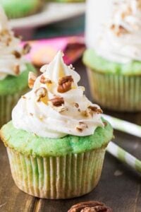Watergate Cupcakes flavored with pistachio pudding and pineapple. Topped with a marshmallow fluff frosting.