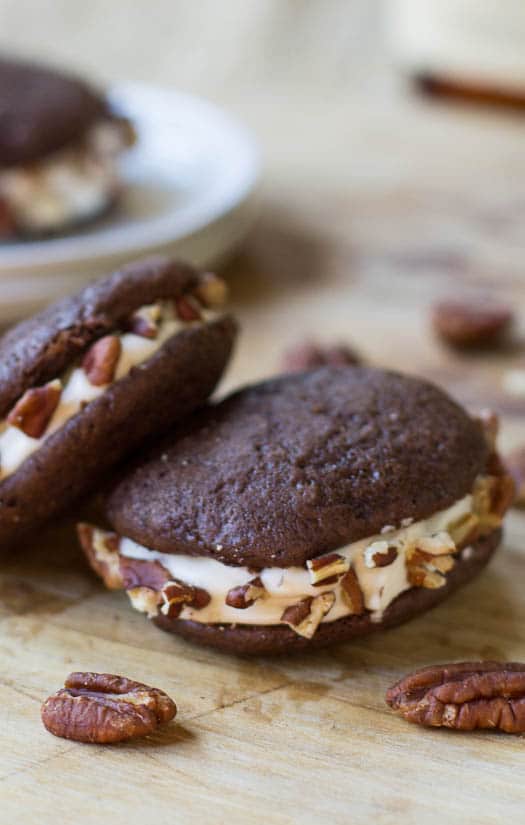 Close-up of Whiskey Whoopie Pies with chopped pecans.